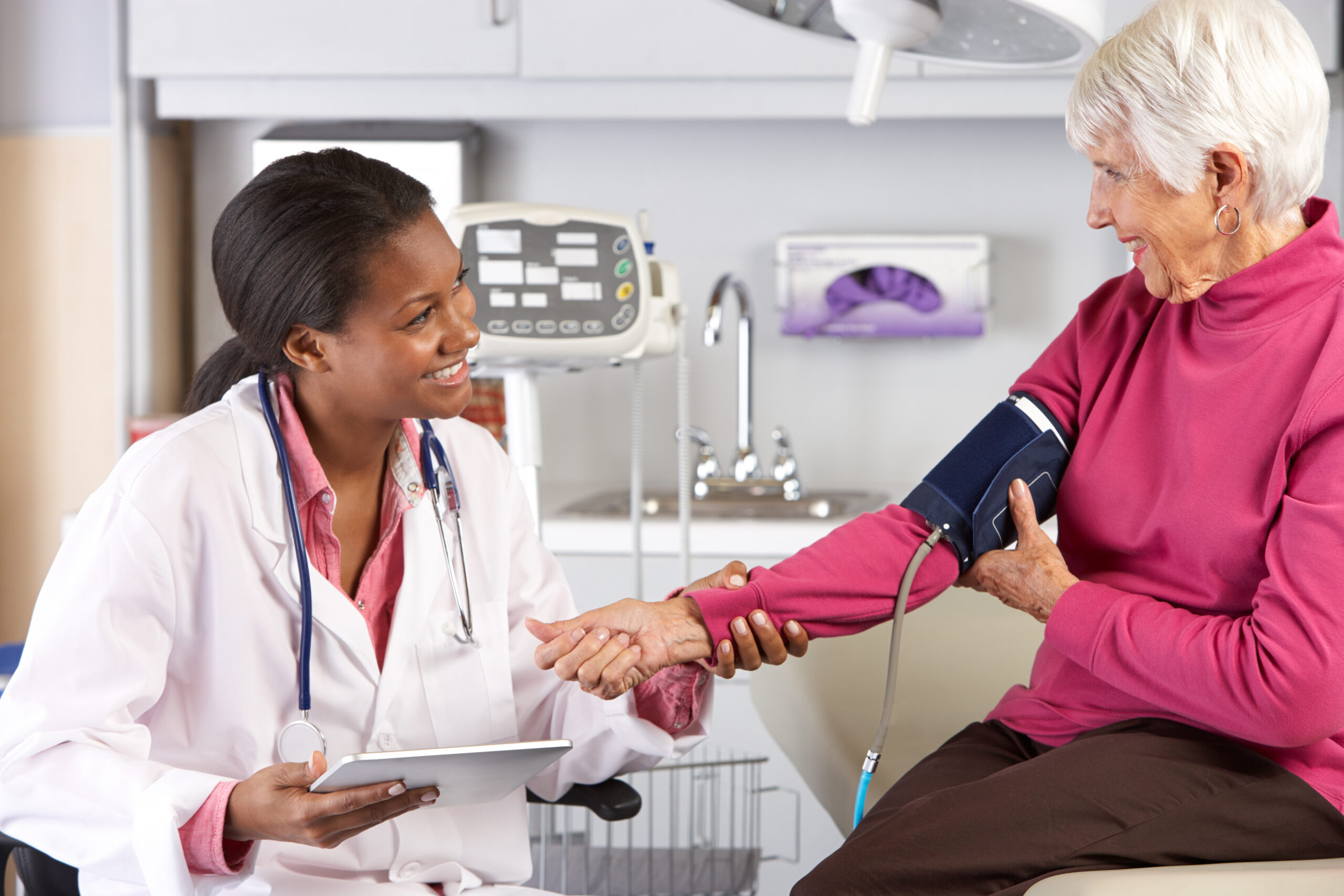 Doctor Taking Senior Female Patient’s Blood Pressure